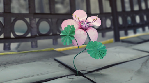 Eine Blume mit rosa Blüten wächst aus einer Spalte im Asphalt.